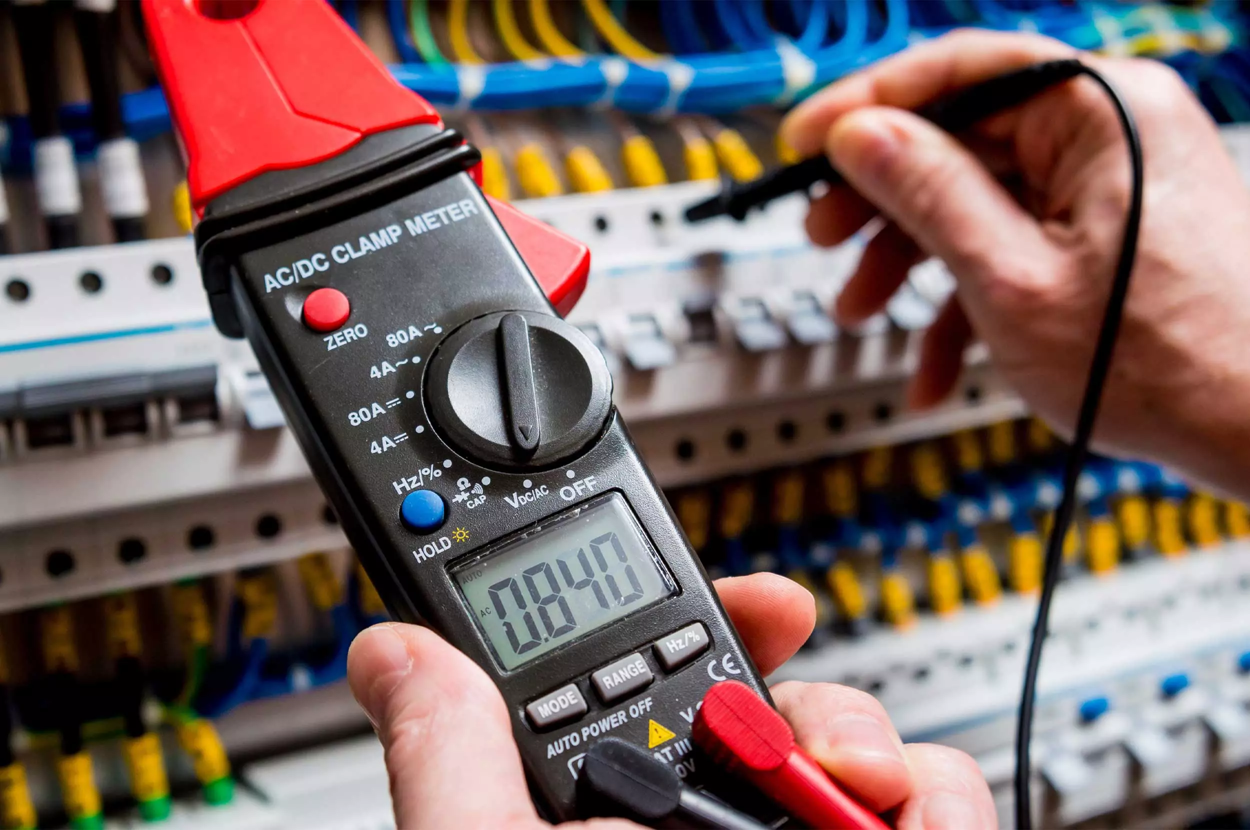 Multimeter tester being used to show electrical measurements.