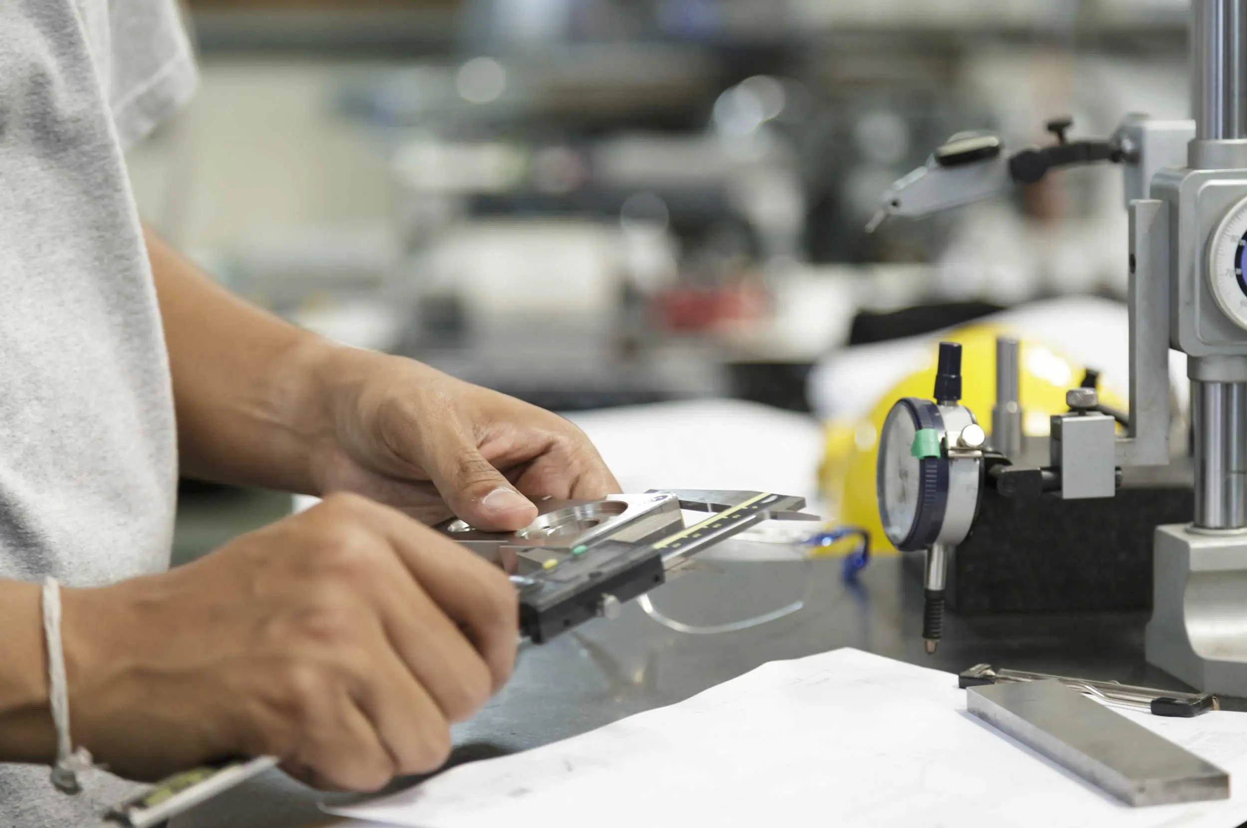 Technician measuring a part by vernier caliper