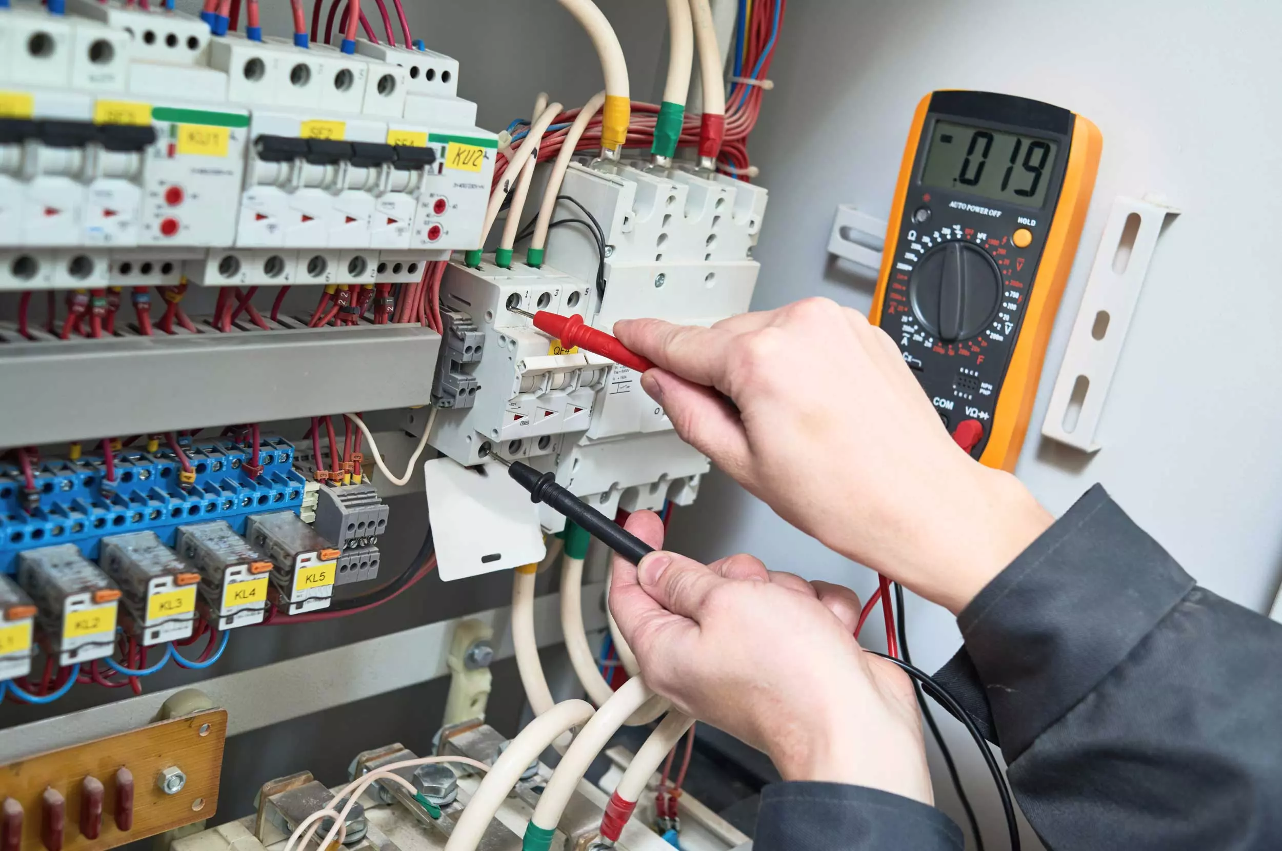 Electrician measures with multimeter tester